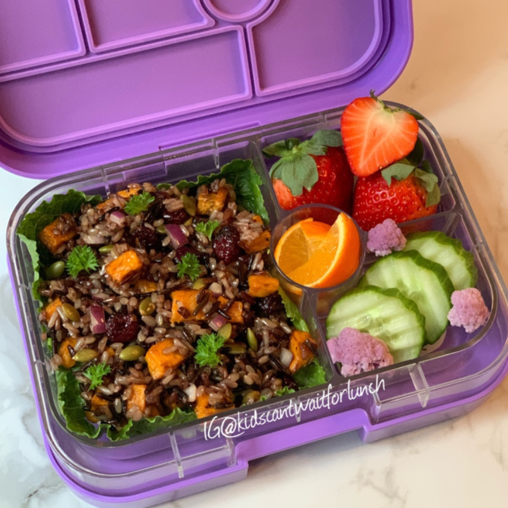 Teuko Lunchbox Community. a salad made of wild rice, with roasted sweet potato, dried cranberries, and pumpkin seeds.